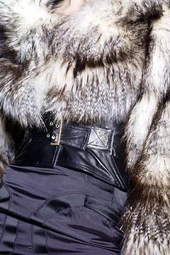 Tom Ford for Gucci FW03 black silk corset skirt runway detail: close-up of high waist with square hardware belt buckle, styled with fur coat, Gucci Fall Winter 2003 show