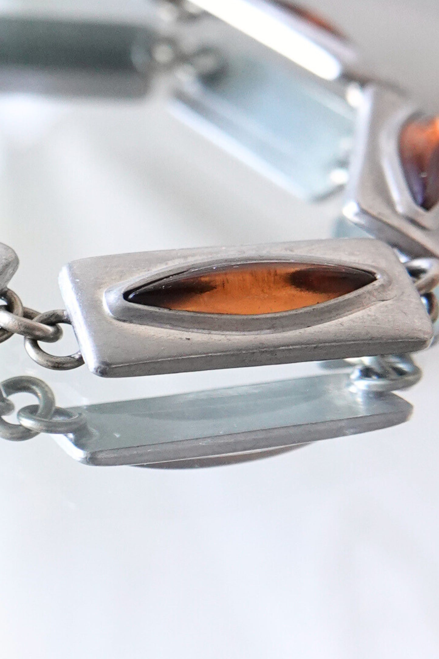 Jørgen Jensen pewter bracelet — macro detail of single link, cognac amber glass cabochon