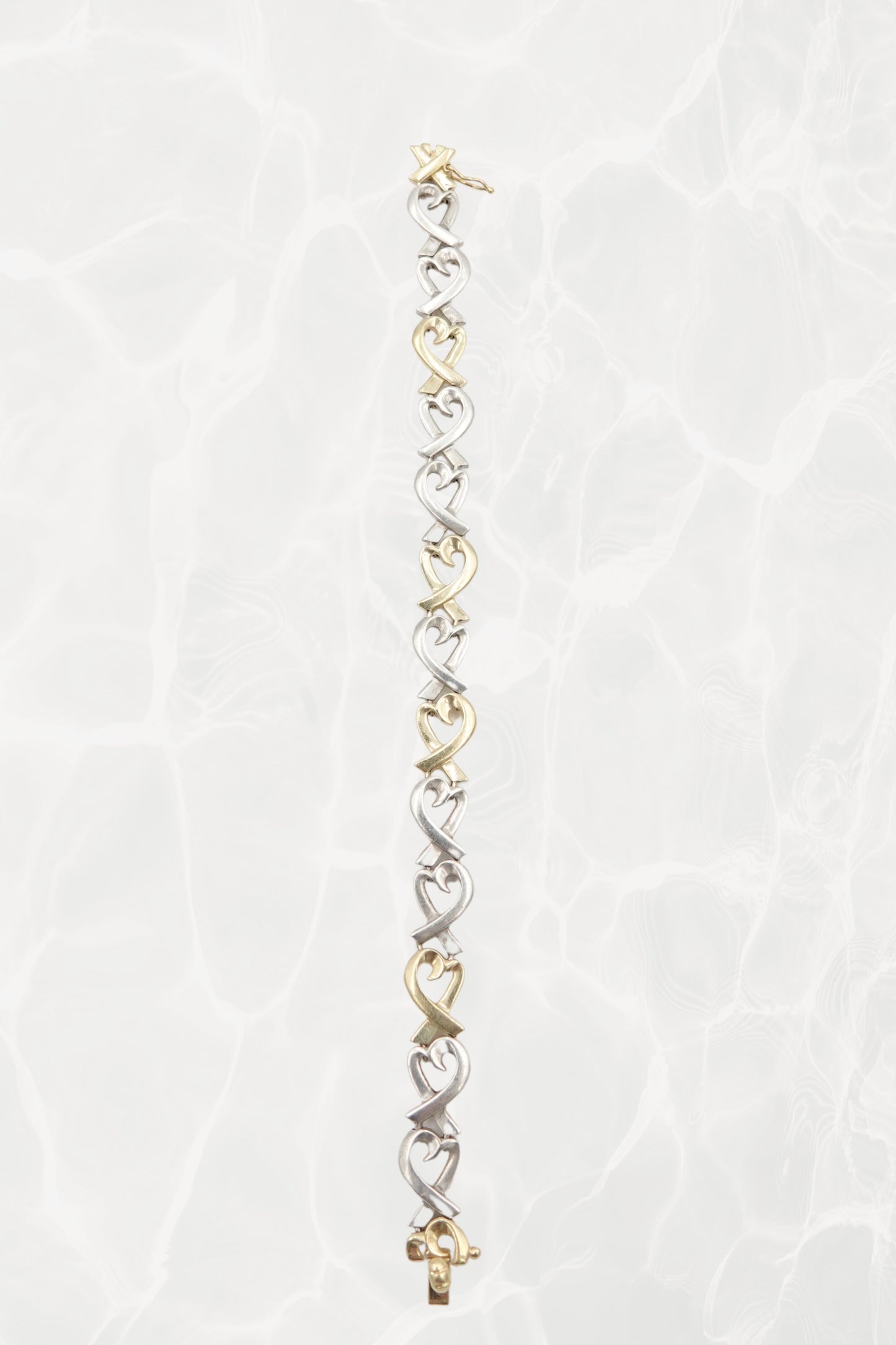 Paloma Picasso for Tiffany & Co. Loving Heart link bracelet: worn on wrist view showing scale, drape and elegance of the sterling silver and 18k gold heart link design