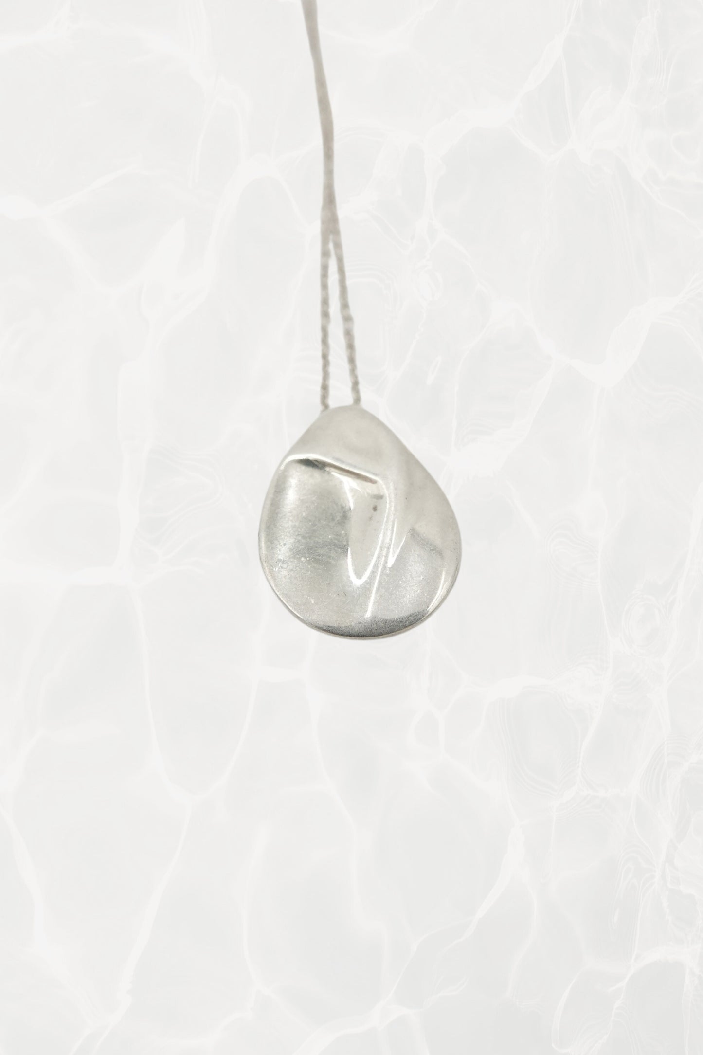 Elsa Peretti for Tiffany & Co. sterling silver Madonna pendant necklace: detailed close-up of chain links and lobster clasp showing quality sterling silver construction