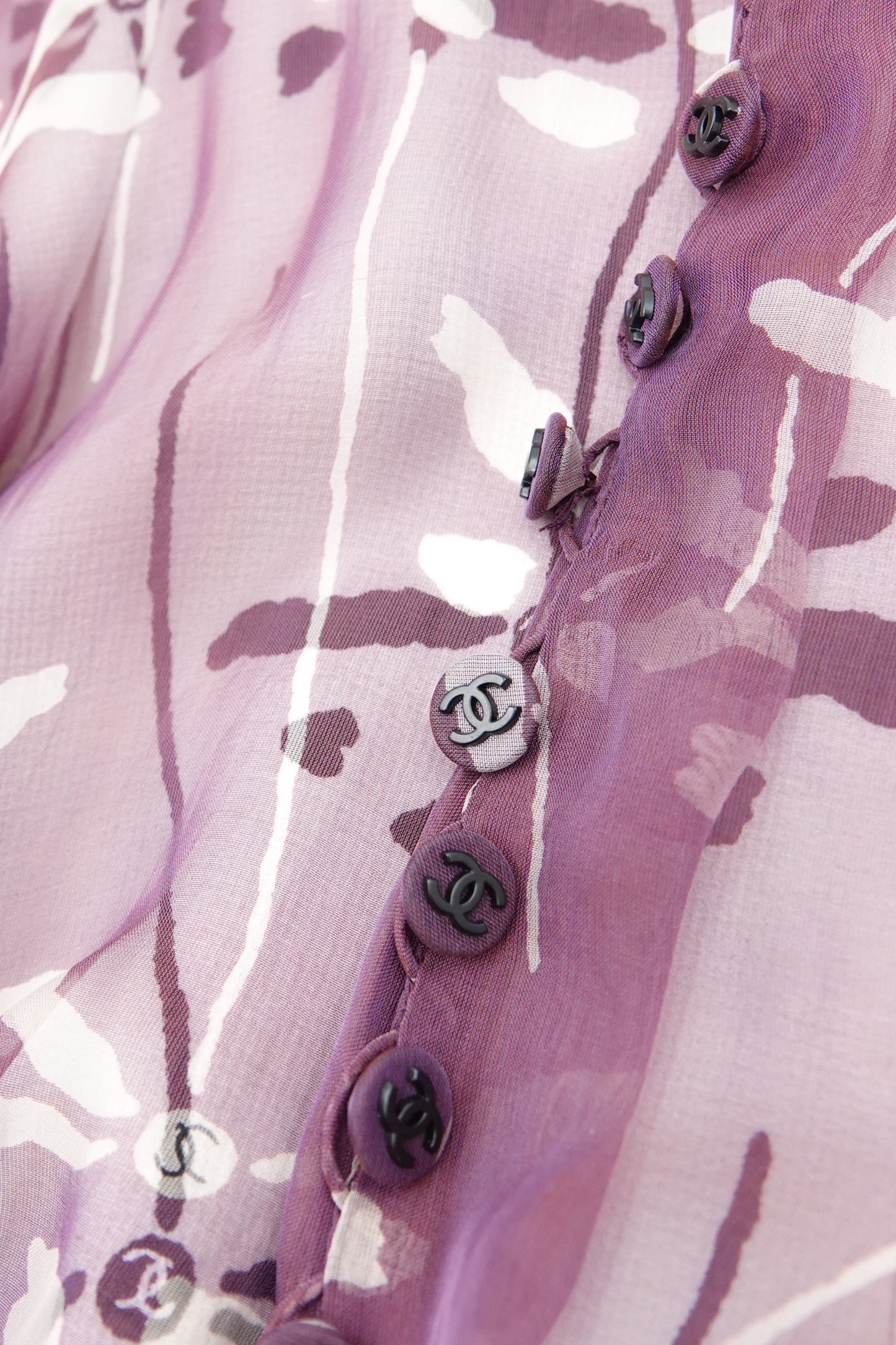 Chanel 98P dragonfly dress CC button detail: row of mauve CC interlace logo buttons along back opening, on mauve dragonfly print silk chiffon fabric, Spring 1998