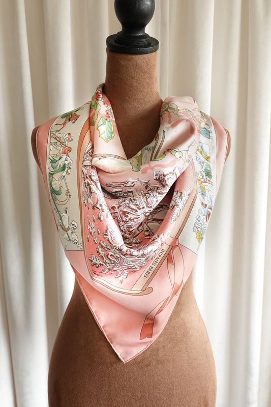 Hermès Neige d'Antan Carré 90 silk scarf styled on mannequin, pink ground with winter botanical motif