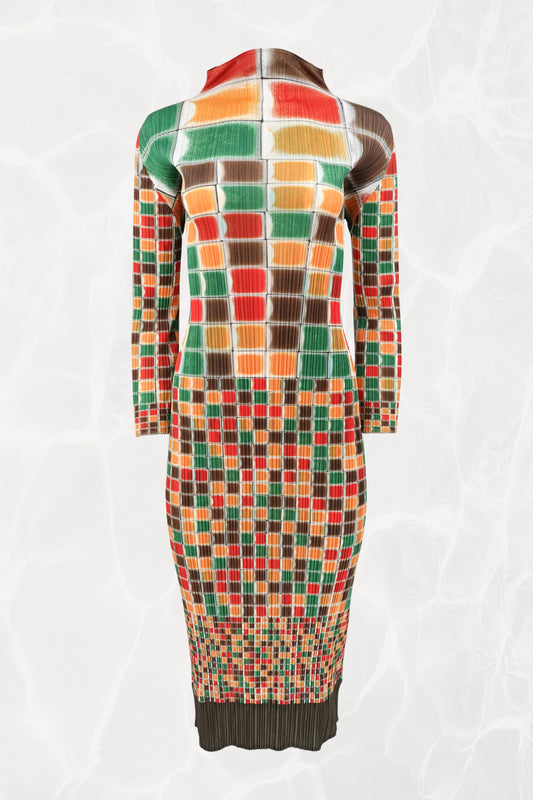 Pleats Please Issey Miyake SS94 sculptural mosaic print midi dress front view: full-length multicolor grid print in red, orange, green, and brown on pleated fabric, long sleeves, high neck, Spring/Summer 1994