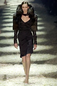 Tom Ford for Gucci FW03 black silk corset skirt on runway: model wearing skirt with black fur jacket and choker neckline, full-length runway look, Gucci Fall Winter 2003 show