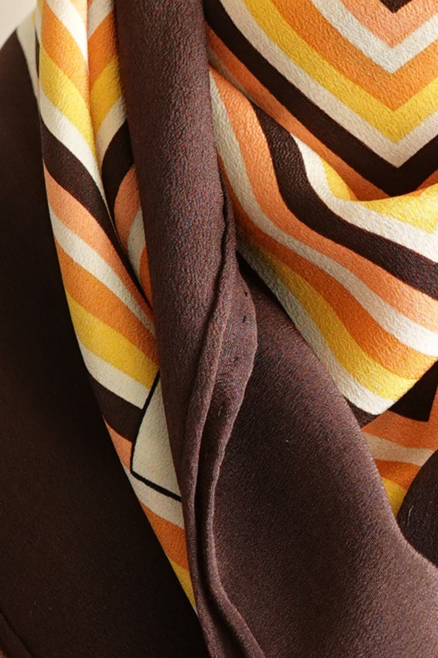 1970s YSL Yves Saint Laurent silk scarf: full view from distance showing the complete geometric composition of the concentric square border print in brown and orange