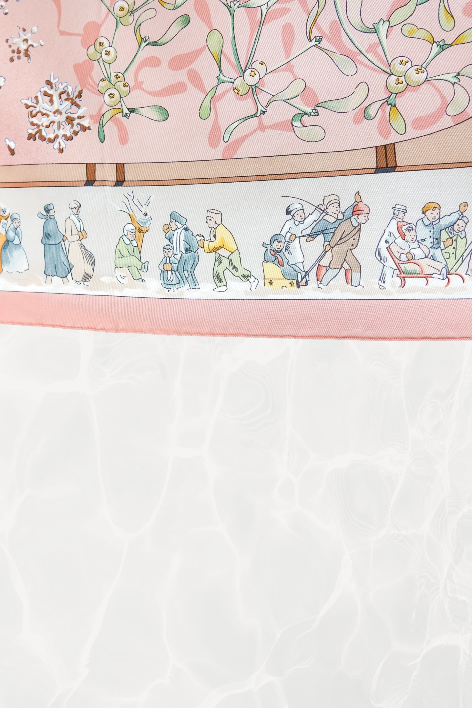 Hermès Neige d'Antan Carré 90 border detail: skiers, sledders, and winter figures in folk-art style on cream ground, pink silk twill