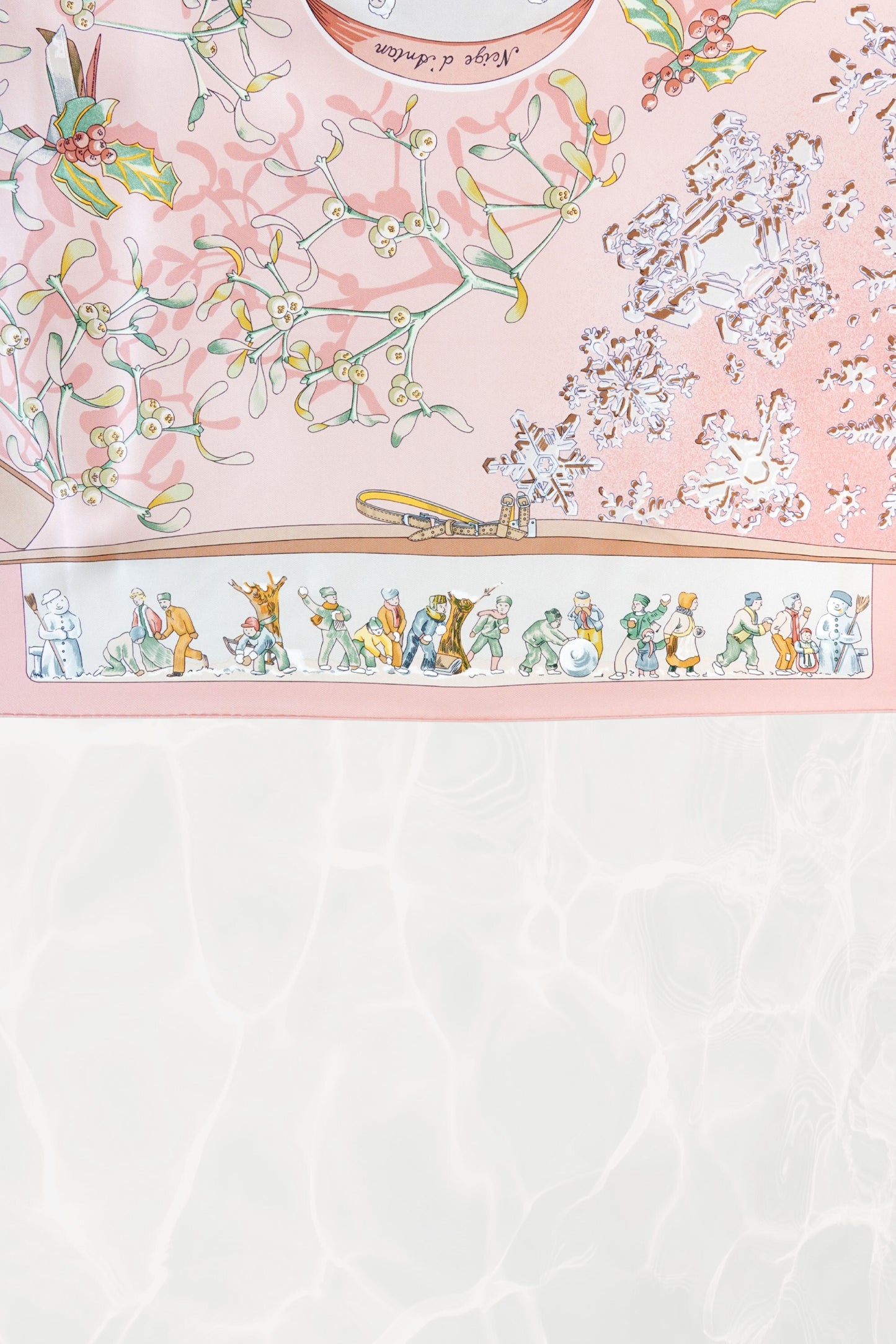 Hermès Neige d'Antan Carré 90 border detail: whimsical winter figures — snowmen, snowball fight, children playing — on cream and pink silk twill