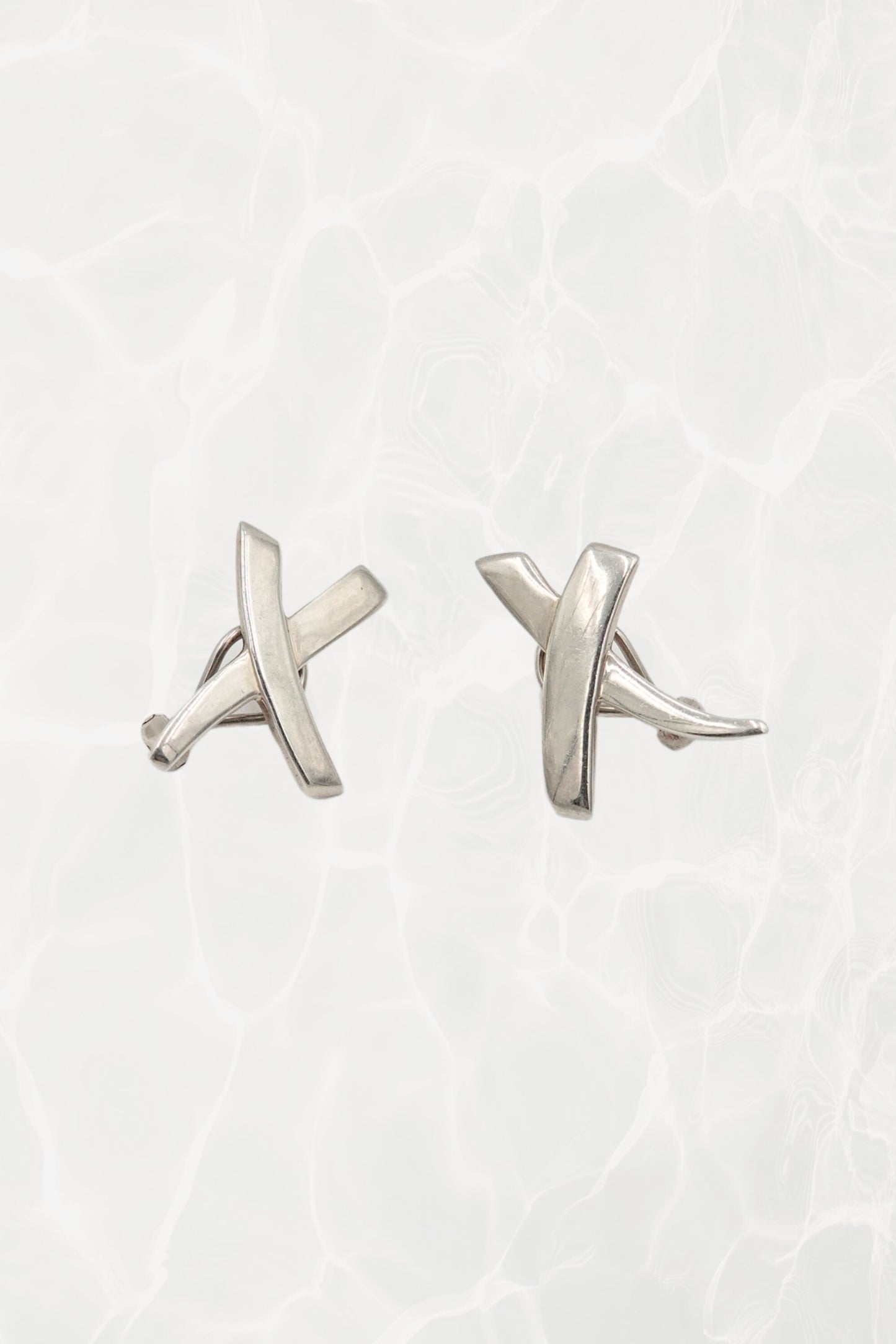 Vintage 1985 Paloma Picasso for Tiffany & Co. sterling silver Kiss X stud earrings: front view showing both earrings with iconic X and kiss motif design