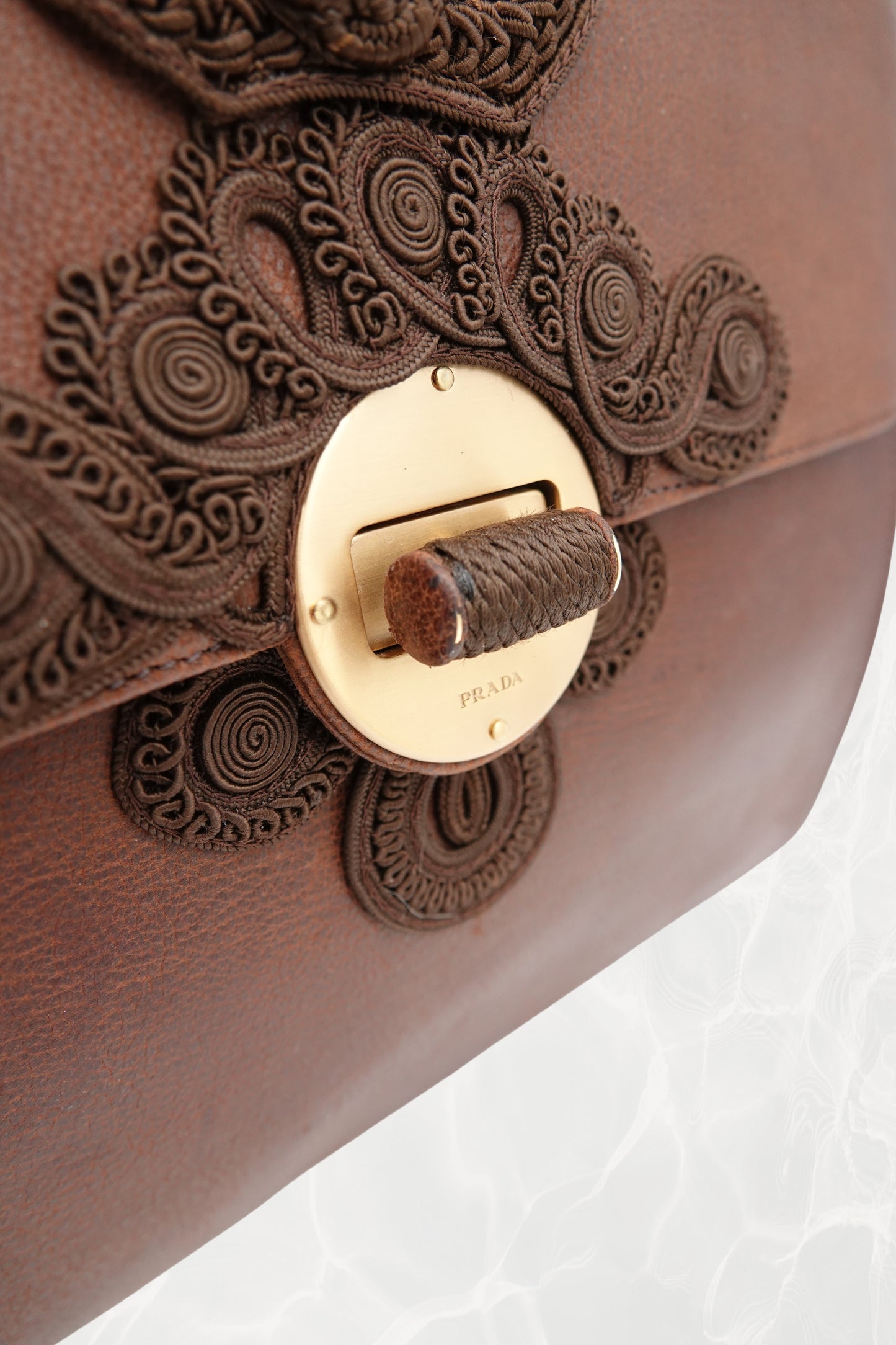 Bottom view of vintage Prada Antic Passamane brown goat leather bag