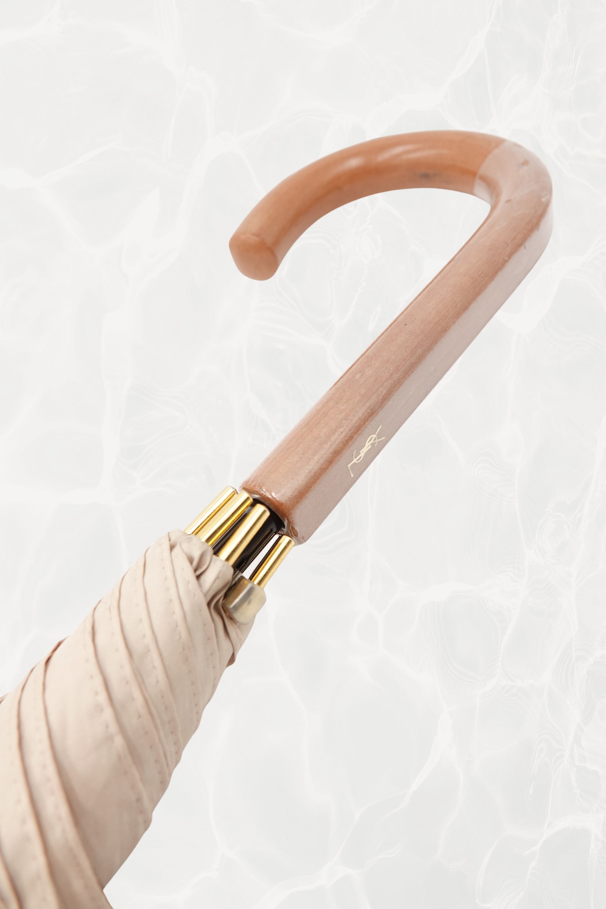 Vintage YSL Yves Saint Laurent gold umbrella: view of the closed canopy showing the fabric colour and overall condition with the gold tip visible