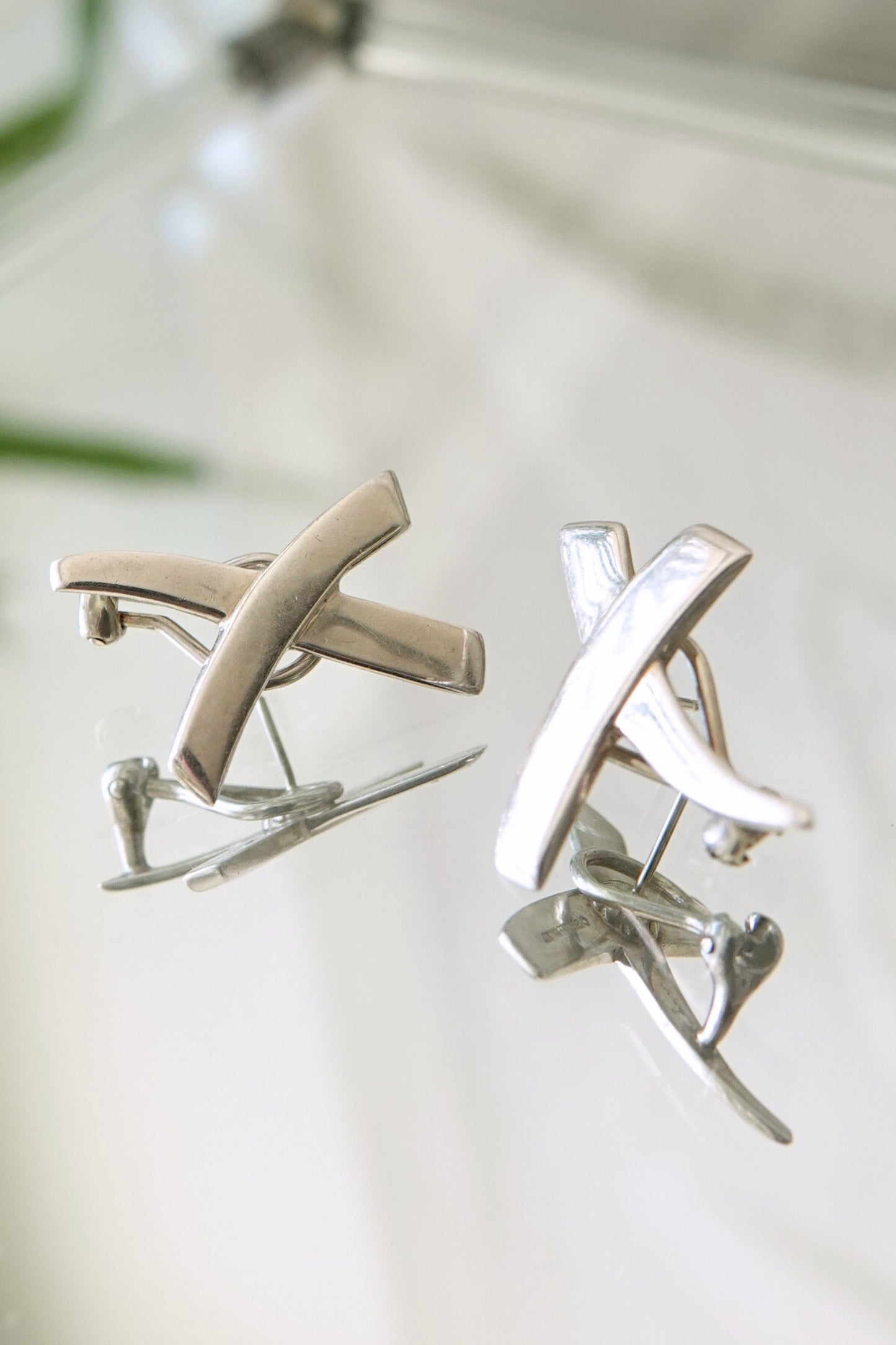 Vintage 1985 Paloma Picasso for Tiffany & Co. sterling silver Kiss X earrings: worn on ear view demonstrating scale and wearability of the sculptural X stud design