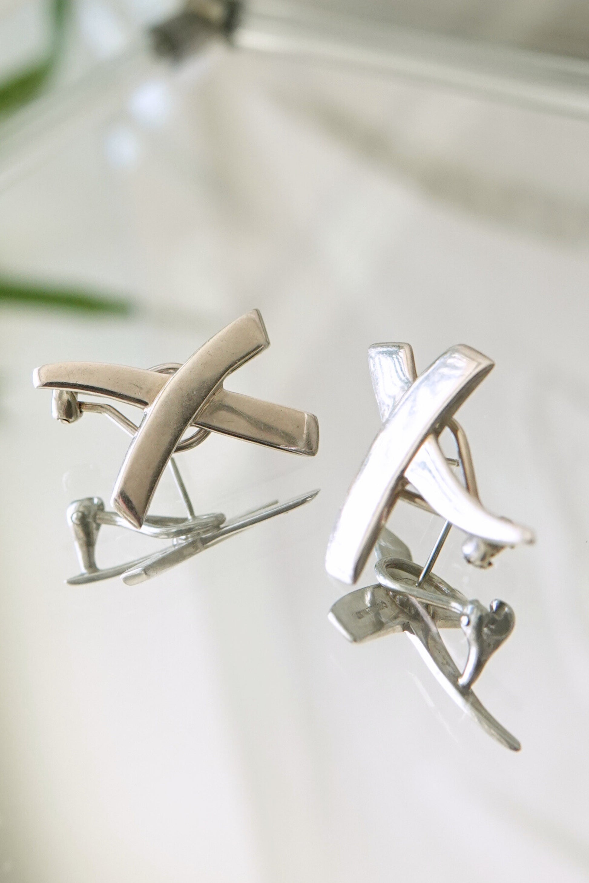 Vintage 1985 Paloma Picasso for Tiffany & Co. sterling silver Kiss X earrings: worn on ear view demonstrating scale and wearability of the sculptural X stud design