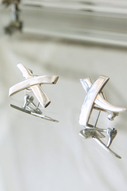 Vintage 1985 Paloma Picasso for Tiffany & Co. sterling silver Kiss X earrings: angled view of earring pair highlighting the bold geometric X shape and high polish finish