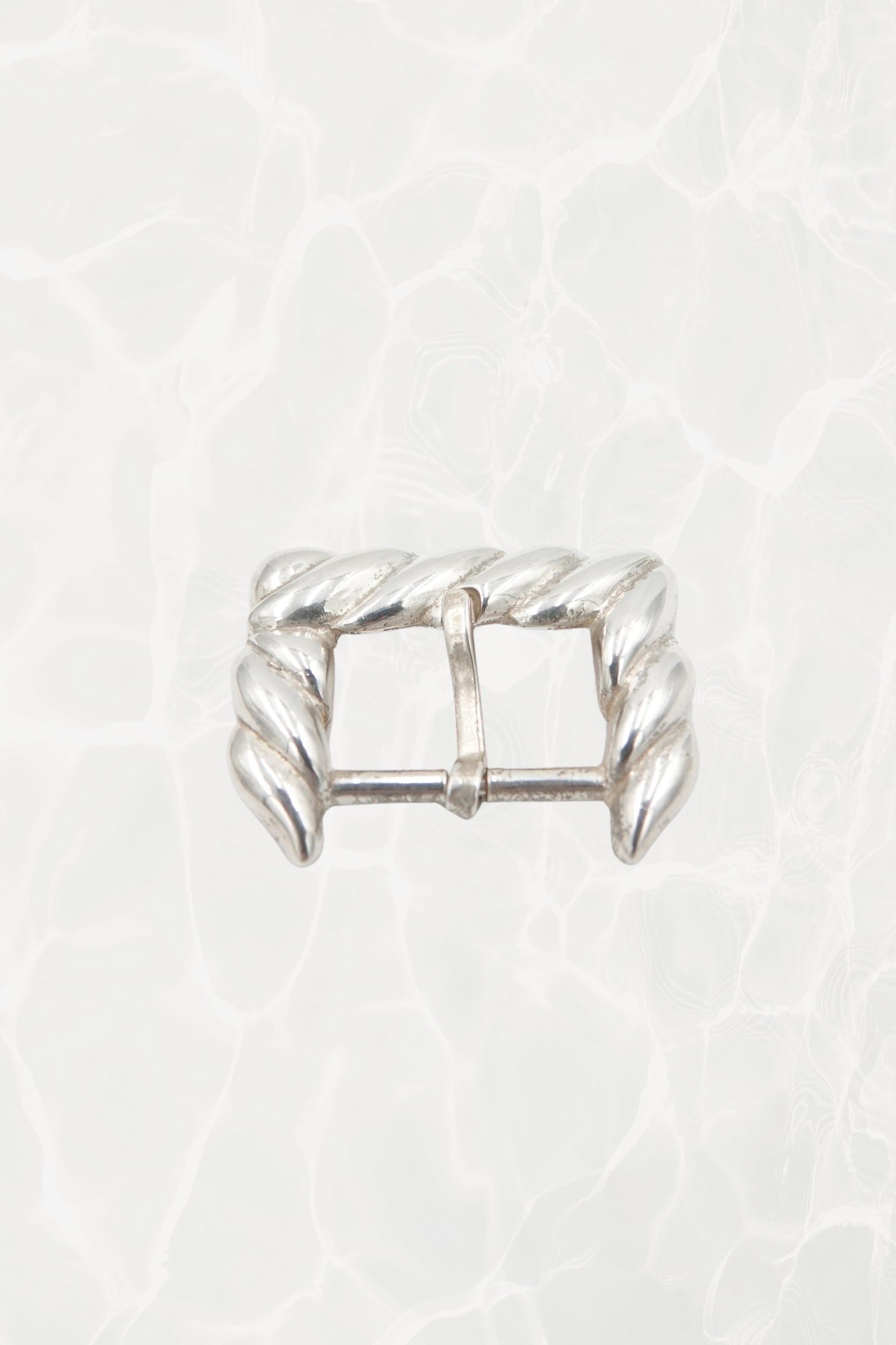 Vintage 1988 Tiffany & Co. sterling silver belt buckle: full front view showing the sculptural rope motif design and overall rectangular buckle form