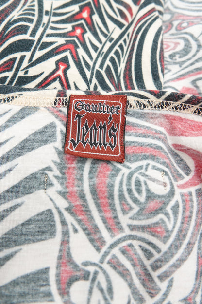 Jean Paul Gaultier JPG Jeans SS96 authentication label close-up: red woven "Gaultier Jeans" gothic script label on Cyberbaba tribal print jersey knit