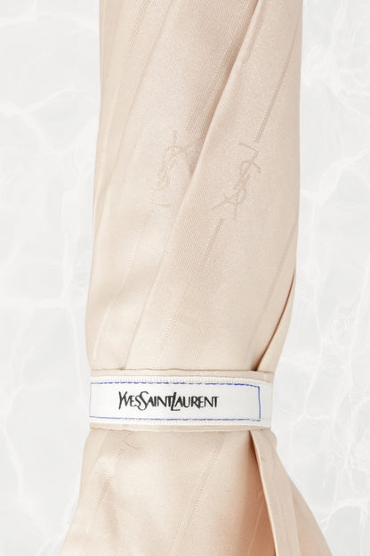 Vintage YSL Yves Saint Laurent gold umbrella: top-down view showing the canopy spread and fabric panels radiating from the central shaft