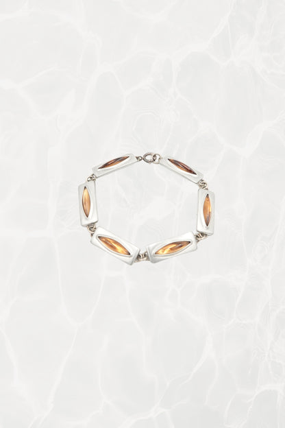 Jørgen Jensen pewter and amber glass link bracelet, Denmark — full piece coiled, pool background