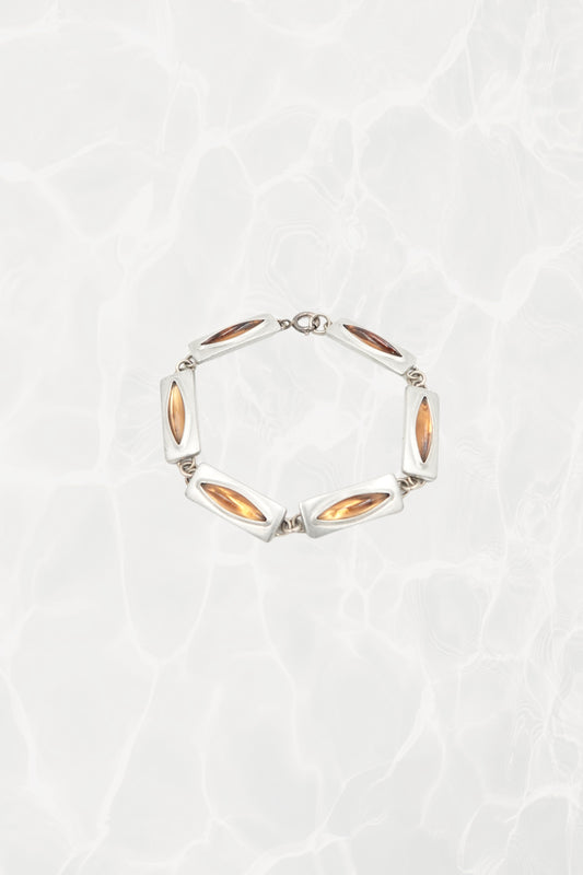 Jørgen Jensen pewter and amber glass link bracelet, Denmark — full piece coiled, pool background