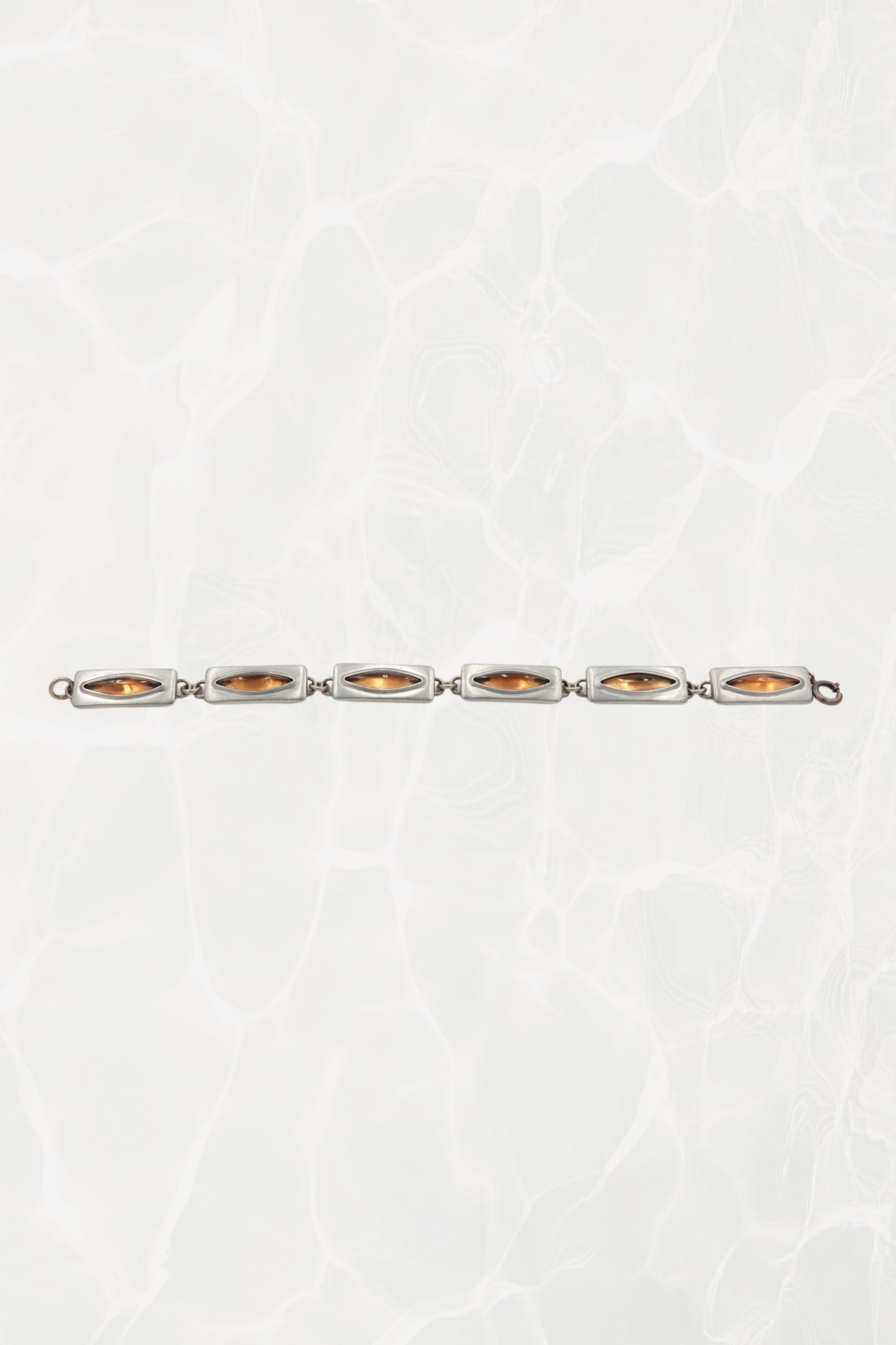 Jørgen Jensen pewter bracelet — laid flat showing all six amber glass links in a line