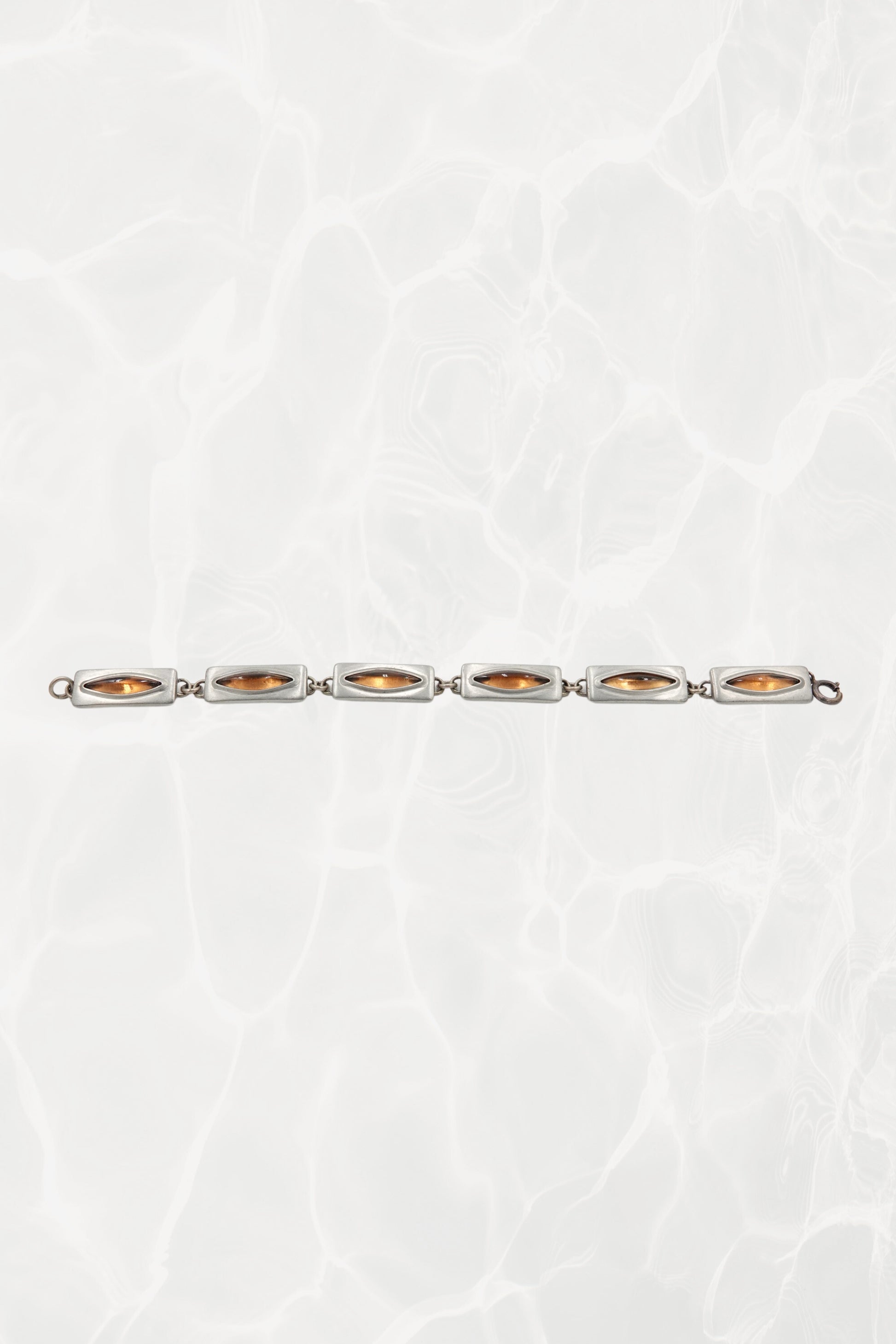 Jørgen Jensen pewter bracelet — laid flat showing all six amber glass links in a line