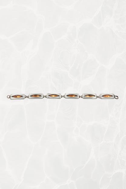 Jørgen Jensen pewter bracelet — laid flat showing all six amber glass links in a line