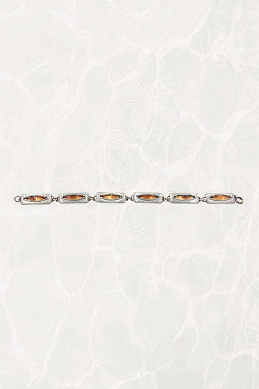 Jørgen Jensen pewter bracelet — laid flat showing all six amber glass links in a line