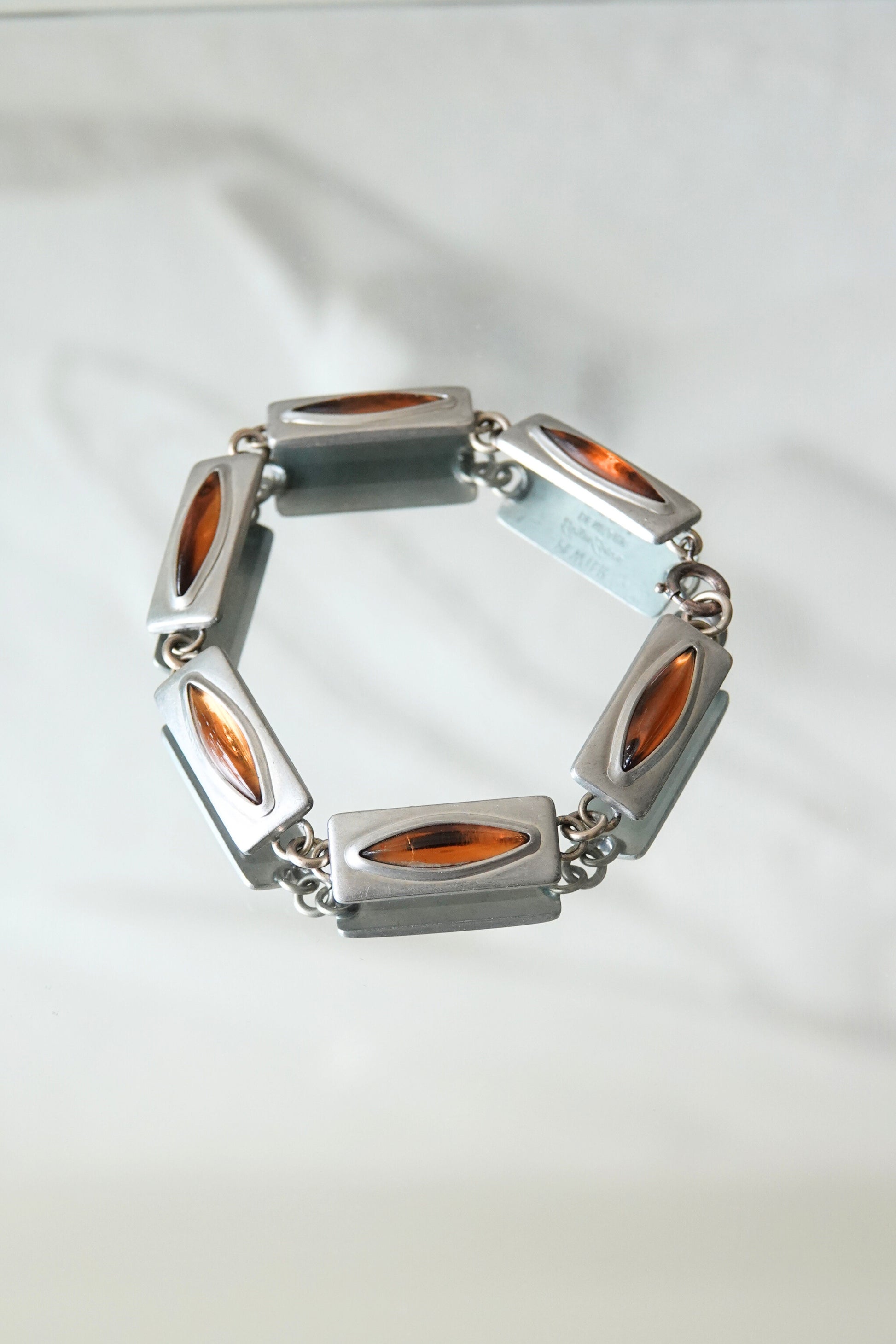 Jørgen Jensen pewter bracelet — styled on white surface, angled view showing link construction