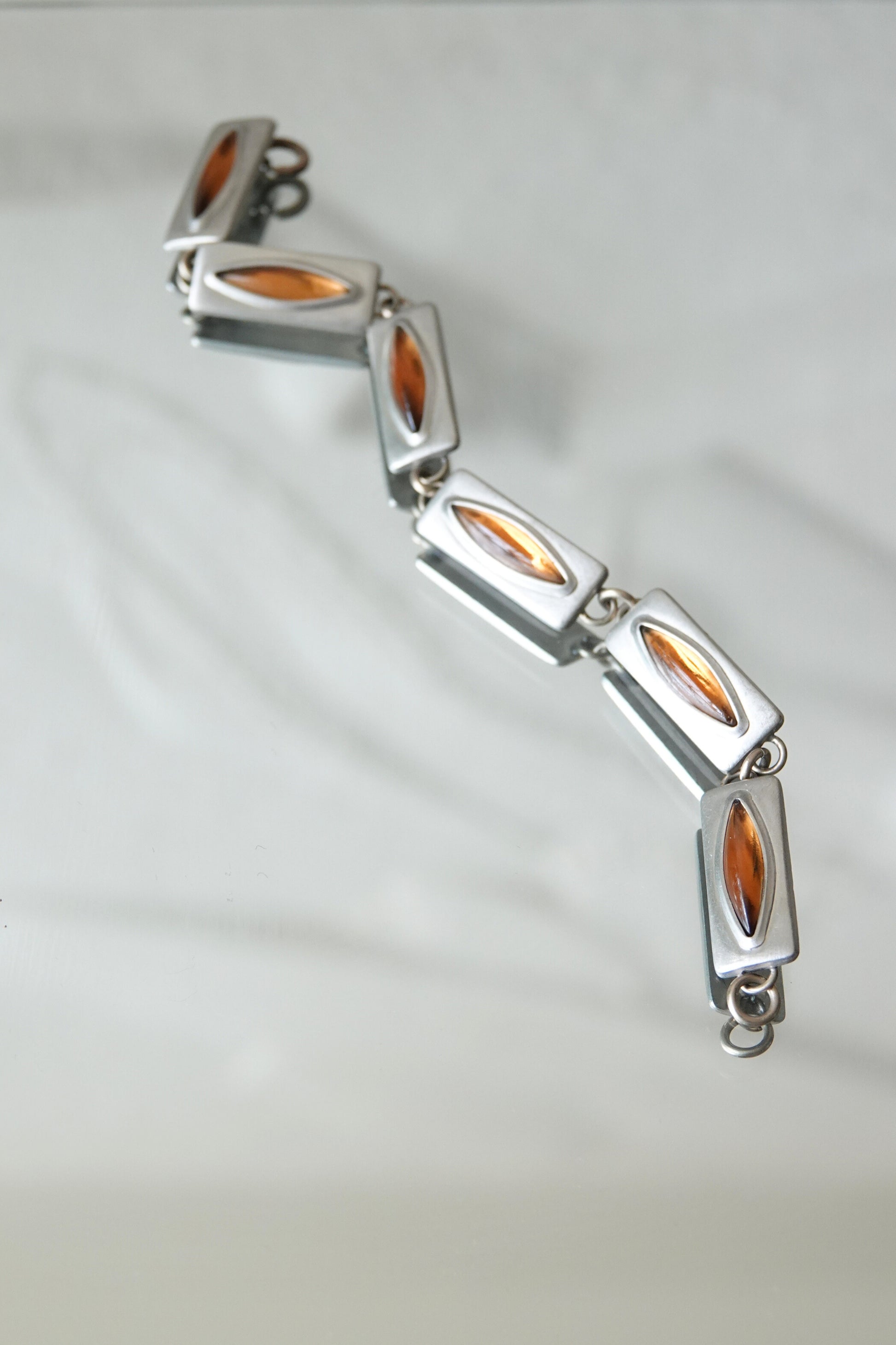 Jørgen Jensen pewter bracelet — diagonal flat lay showing link and chain connector detail