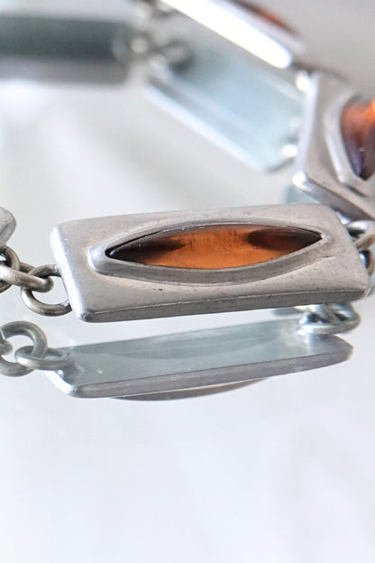 Jørgen Jensen pewter bracelet — macro detail of single link, cognac amber glass cabochon