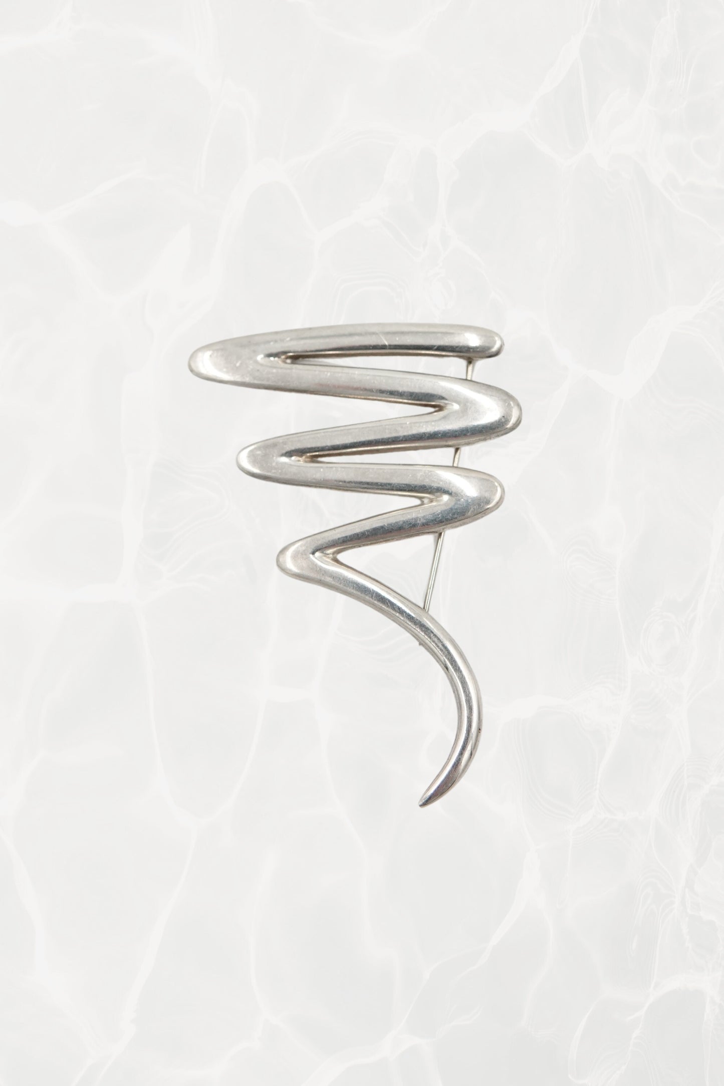 Vintage Paloma Picasso sterling silver Scribble brooch: front view showing the full abstract expressionist swirl design against neutral background