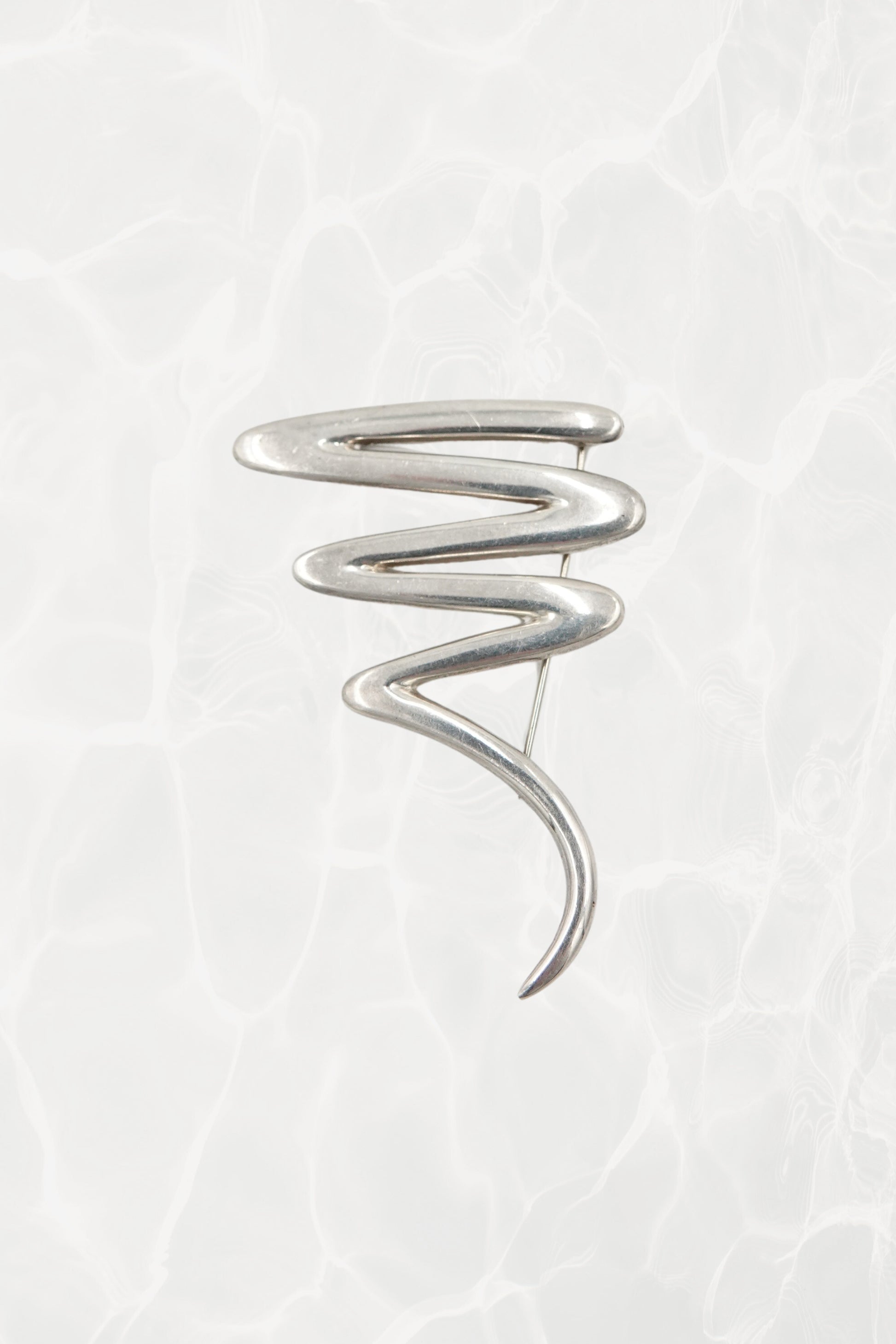 Vintage Paloma Picasso sterling silver Scribble brooch: front view showing the full abstract expressionist swirl design against neutral background