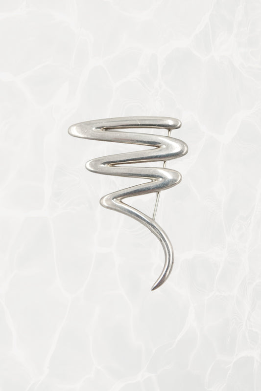 Vintage Paloma Picasso sterling silver Scribble brooch: front view showing the full abstract expressionist swirl design against neutral background