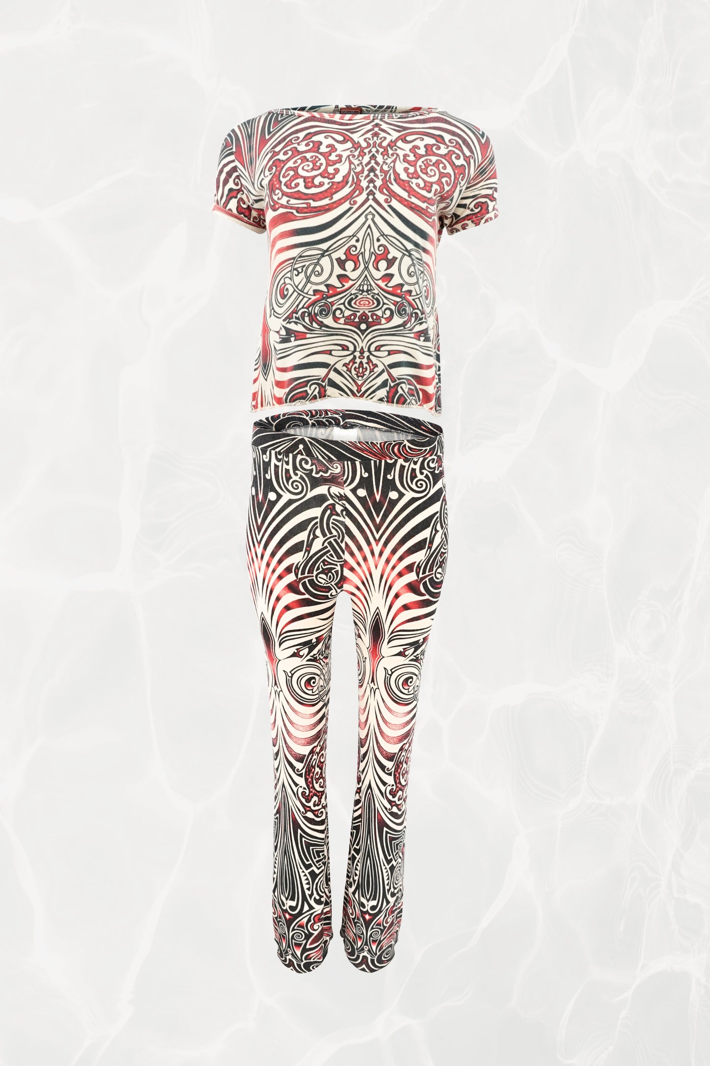Jean Paul Gaultier JPG Jeans SS96 Cyberbaba 2-piece set flat-lay: short-sleeve crop top and pull-on pants in black, white and red tribal tattoo print jersey