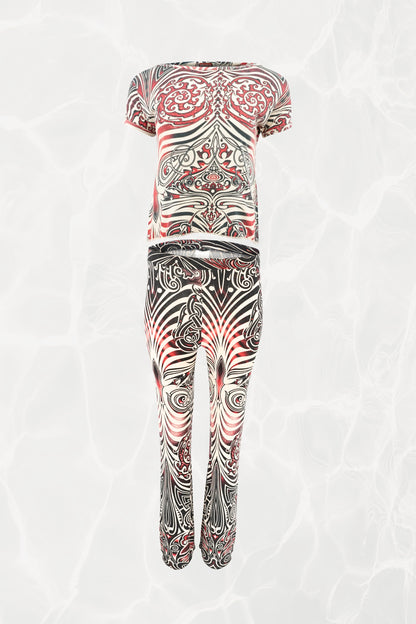 Jean Paul Gaultier JPG Jeans SS96 Cyberbaba 2-piece set flat-lay: short-sleeve crop top and pull-on pants in black, white and red tribal tattoo print jersey