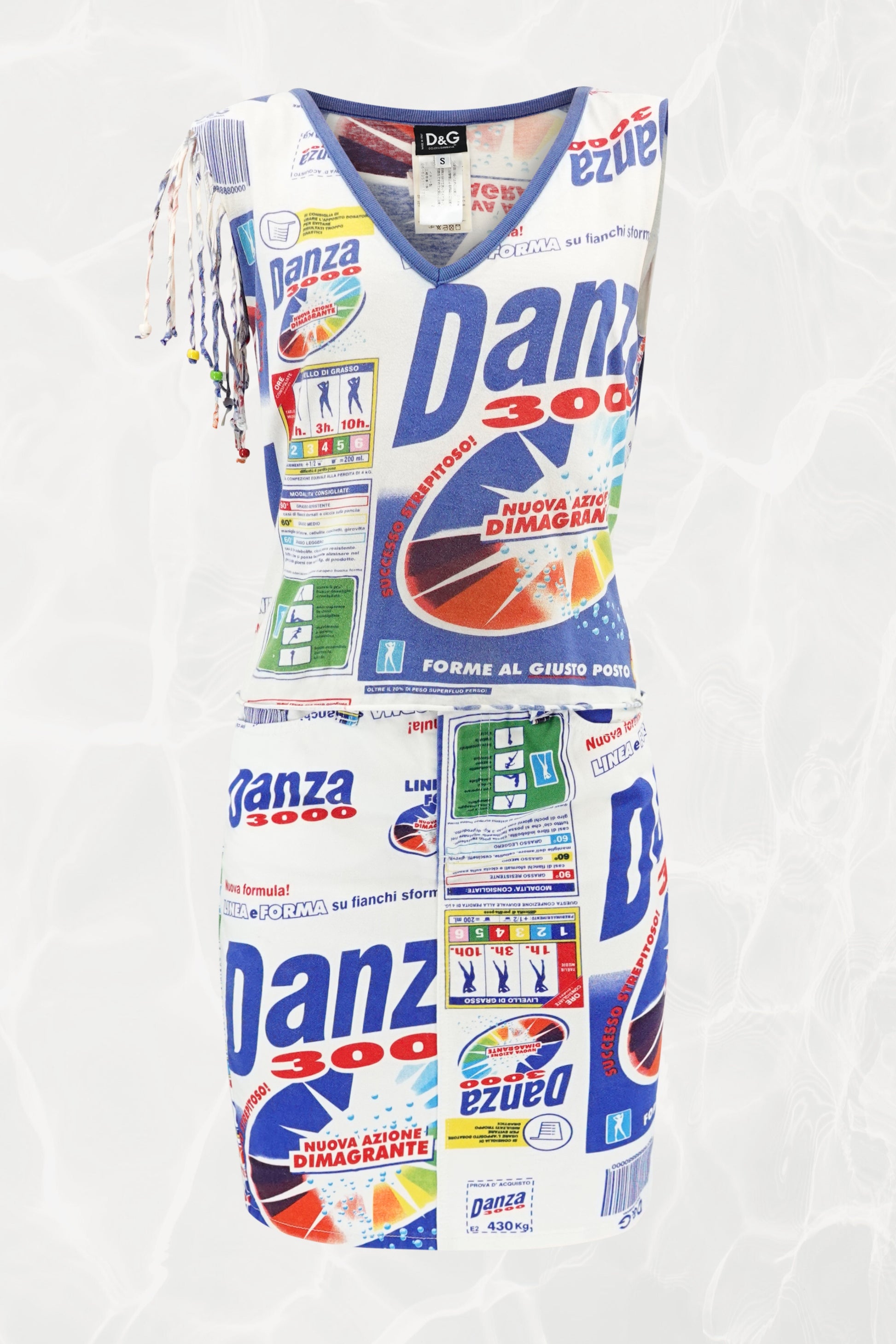 D&G SS02 Danza 3000 set flat-lay: fringe jersey top and denim skirt covered in allover Italian "Danza 3000" slimming product advertising print, blue and white