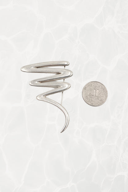 Vintage Paloma Picasso sterling silver Scribble brooch: reverse side view showing the pin stem, safety clasp, and Paloma Picasso signature hallmark on the back