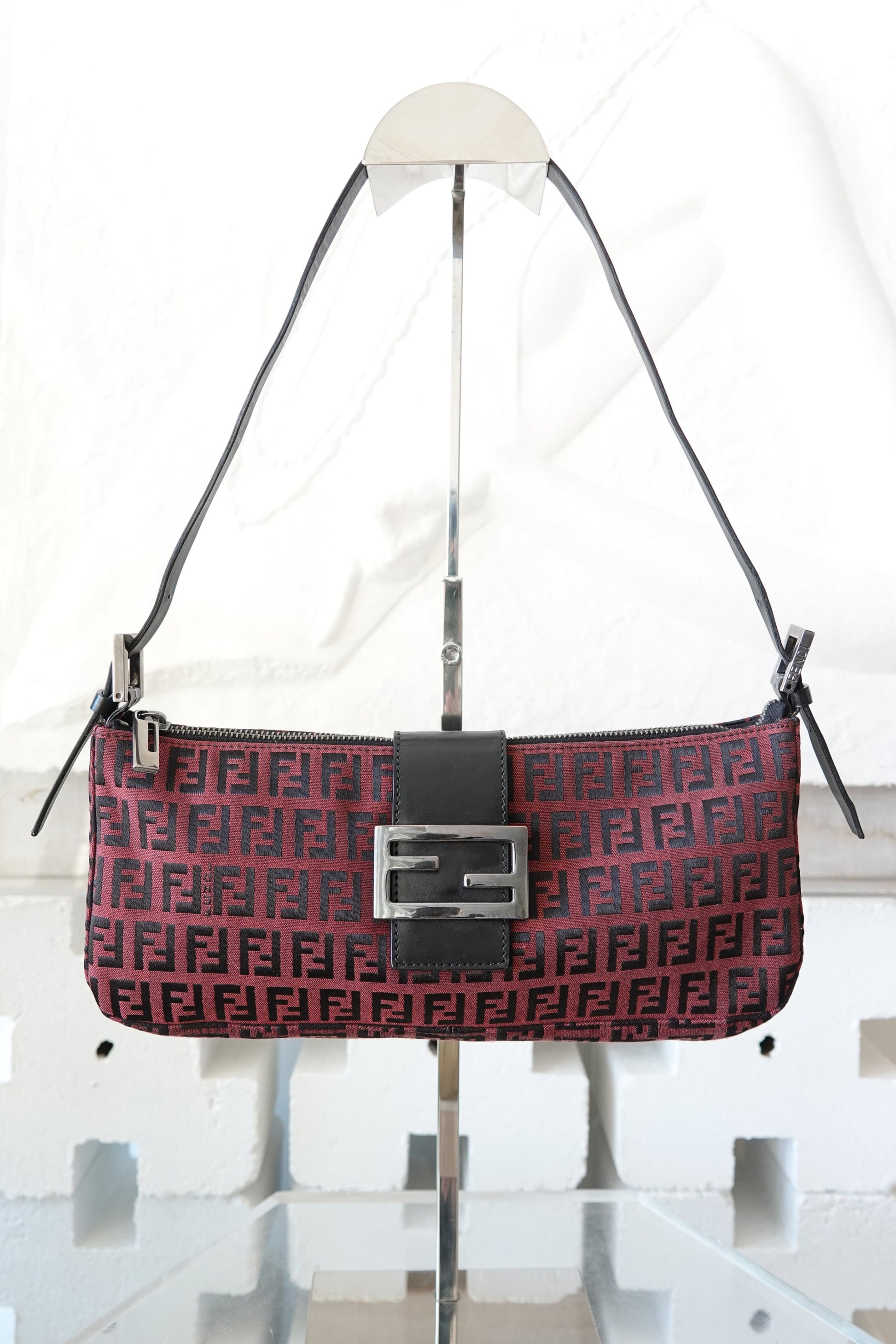 Fendi Zucchino FF monogram baguette, front view on display stand — Disco Palma
