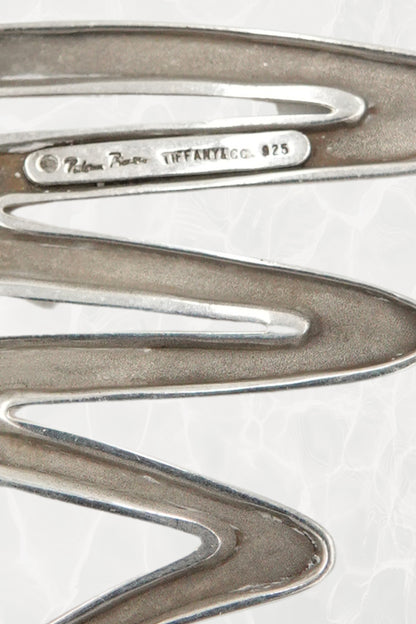 Vintage Paloma Picasso sterling silver Scribble brooch: worn on lapel view showing the scale and bold graphic impact of the abstract silver scribble design