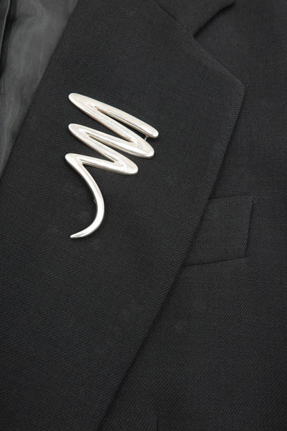 Vintage Paloma Picasso sterling silver Scribble brooch: close-up detail of the fluid abstract scribble motif showing the sculptural wire-like silver form
