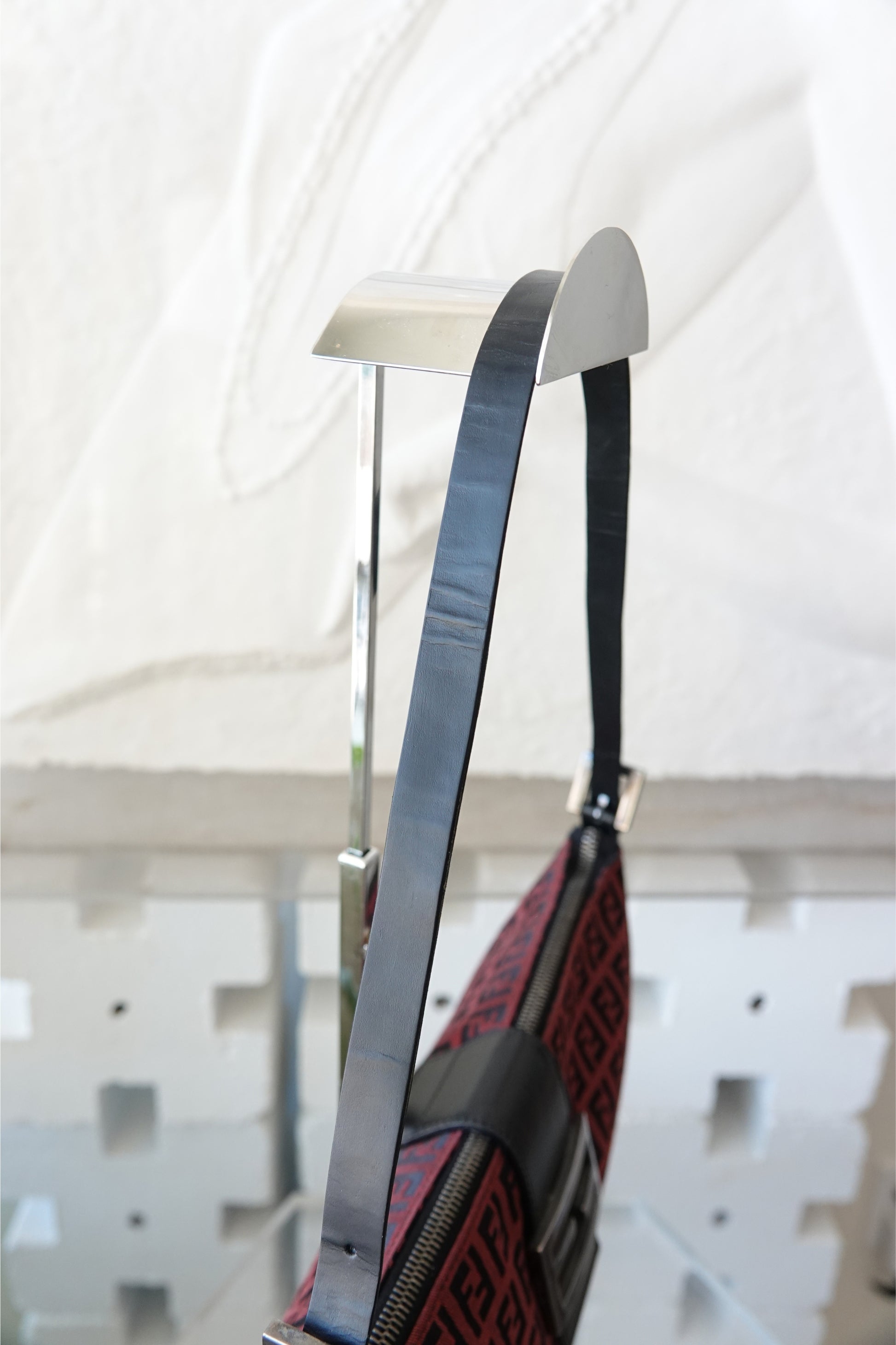 Fendi Zucchino FF monogram baguette, side profile on display stand — Disco Palma