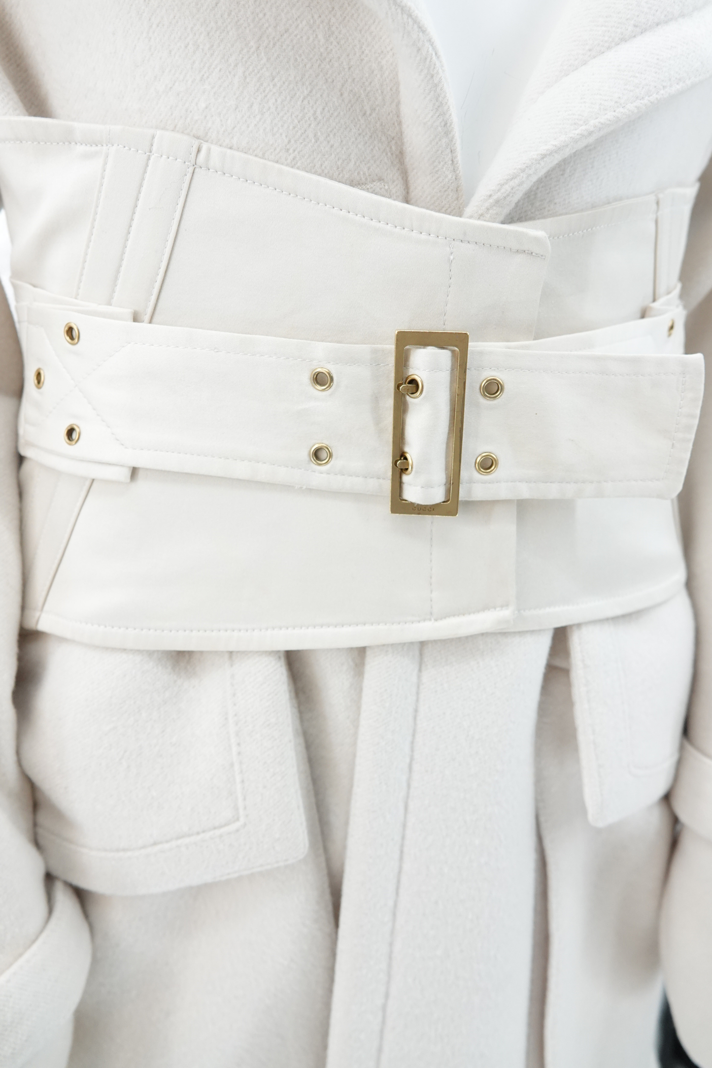 Tom Ford for Gucci AW03 white wool angora coat waist cincher detail: close-up of detachable wide corset belt with gold-tone rectangular buckle and stud hardware, Fall Winter 2003