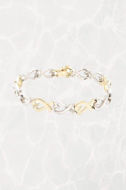 Paloma Picasso for Tiffany & Co. Loving Heart link bracelet in sterling silver and 18k gold: front view showing full bracelet with heart-shaped links against neutral background