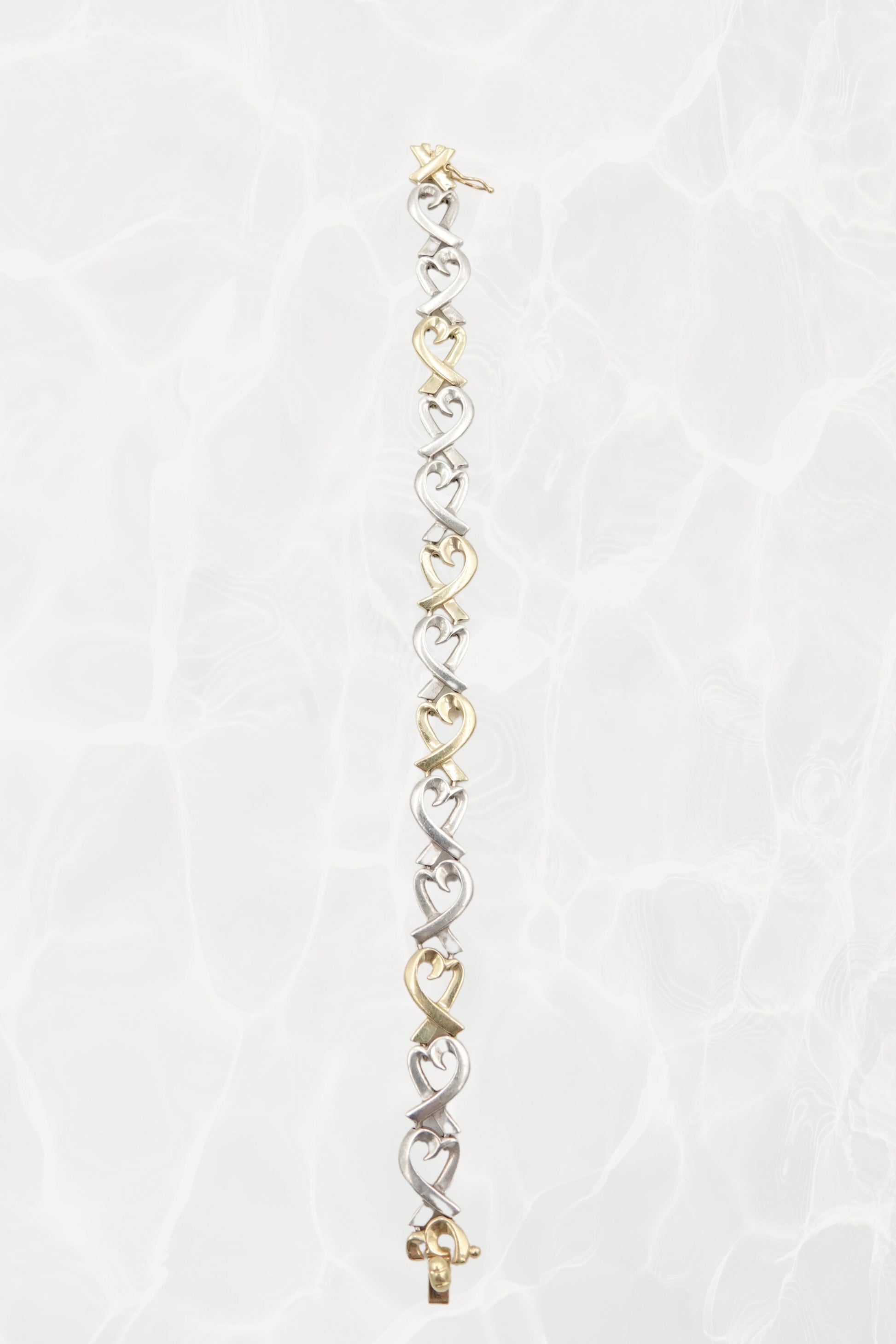 Paloma Picasso for Tiffany & Co. Loving Heart link bracelet: worn on wrist view showing scale, drape and elegance of the sterling silver and 18k gold heart link design