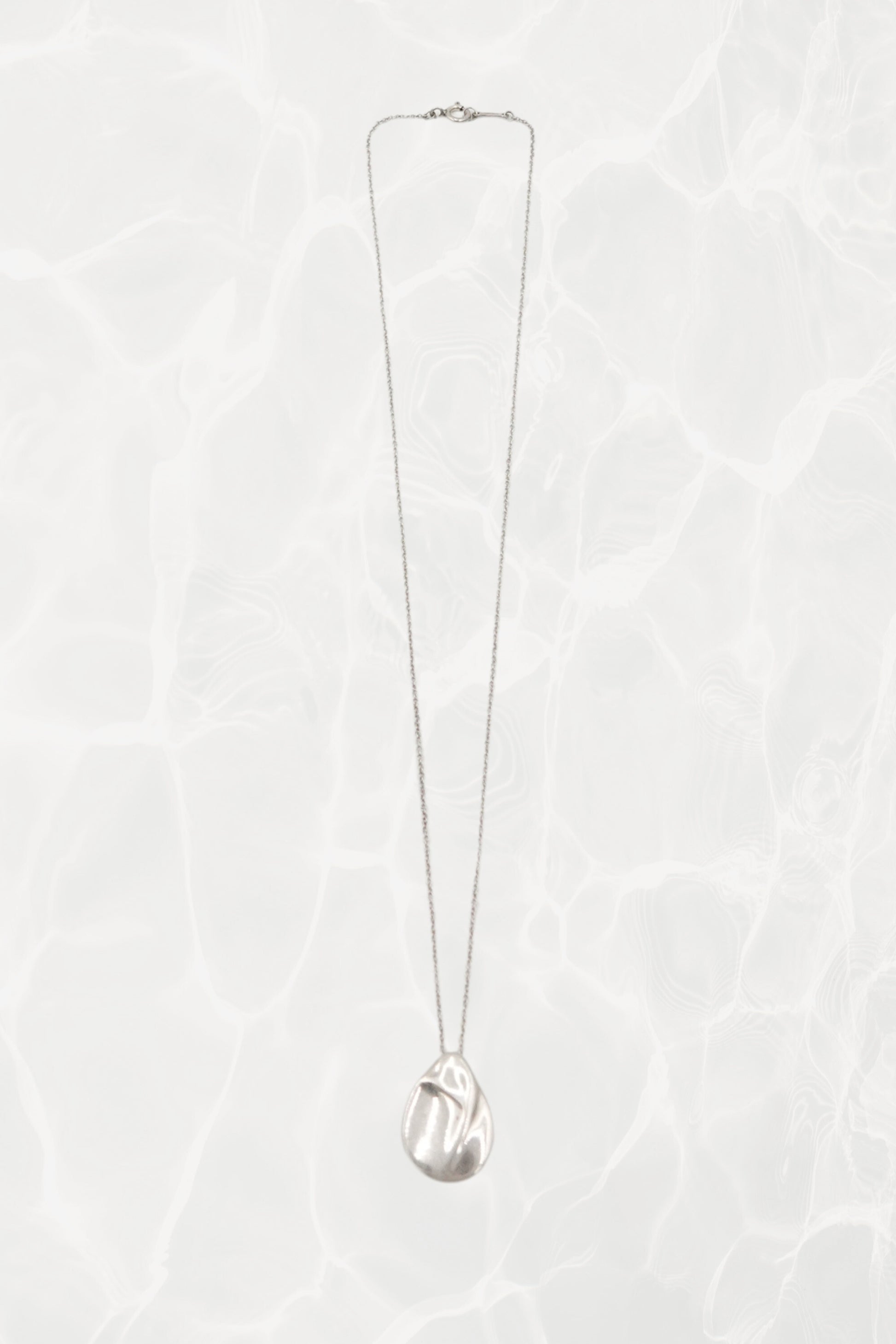 Elsa Peretti for Tiffany & Co. sterling silver Madonna pendant necklace: angled view showing pendant drop and chain length against neutral background