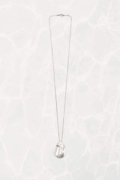 Elsa Peretti for Tiffany & Co. sterling silver Madonna pendant necklace: angled view showing pendant drop and chain length against neutral background