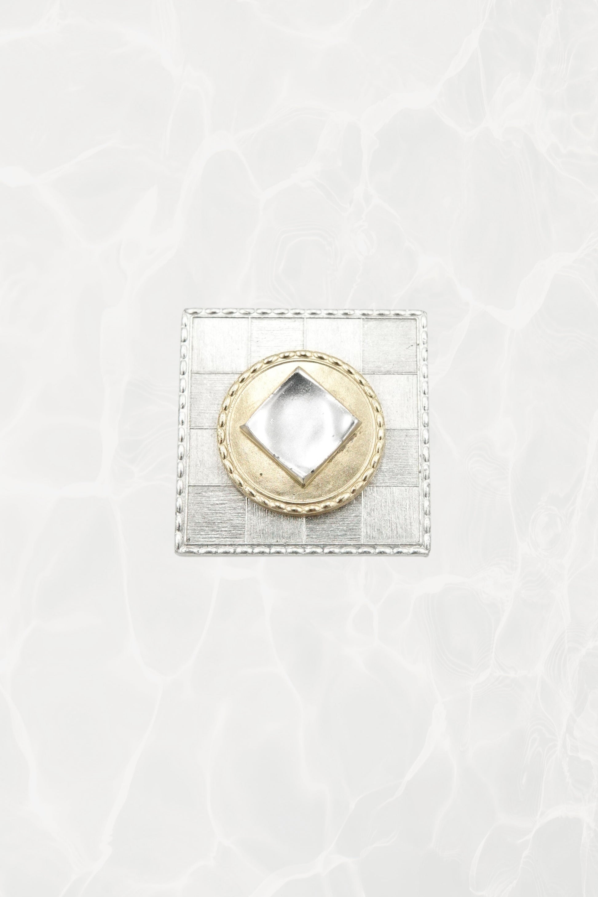 Made in France mixed metal brooch — angled front view