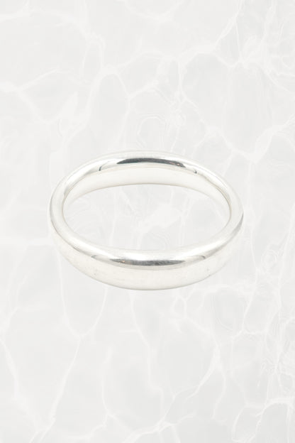 Elsa Peretti for Tiffany & Co. sculptural sterling silver closed bangle overhead view: top-down perspective of smooth oval closed form showing even width and polish of sterling silver