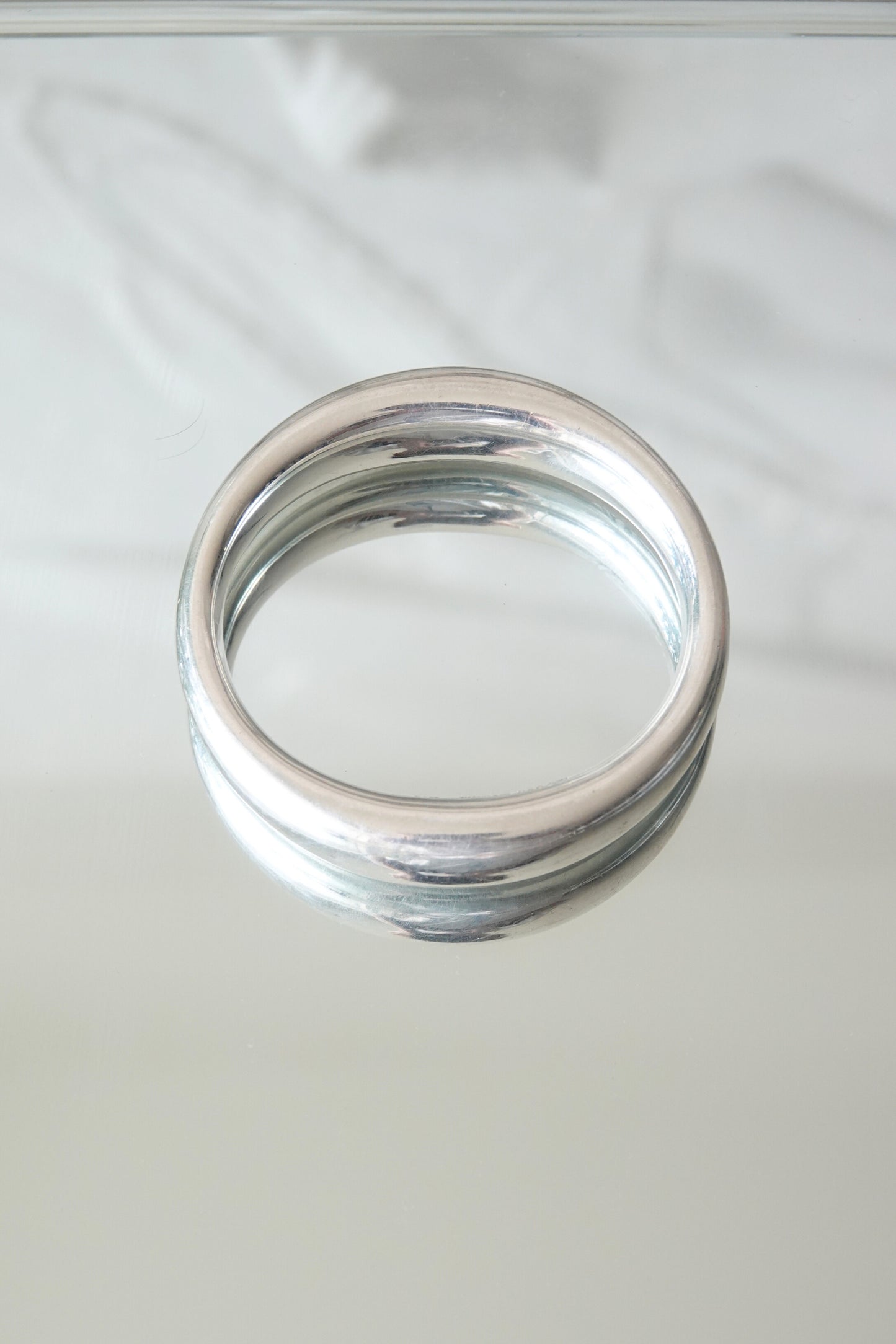 Elsa Peretti for Tiffany & Co. sculptural sterling silver closed bangle detail: close-up showing surface finish and sculptural depth of the smooth organic sterling silver form