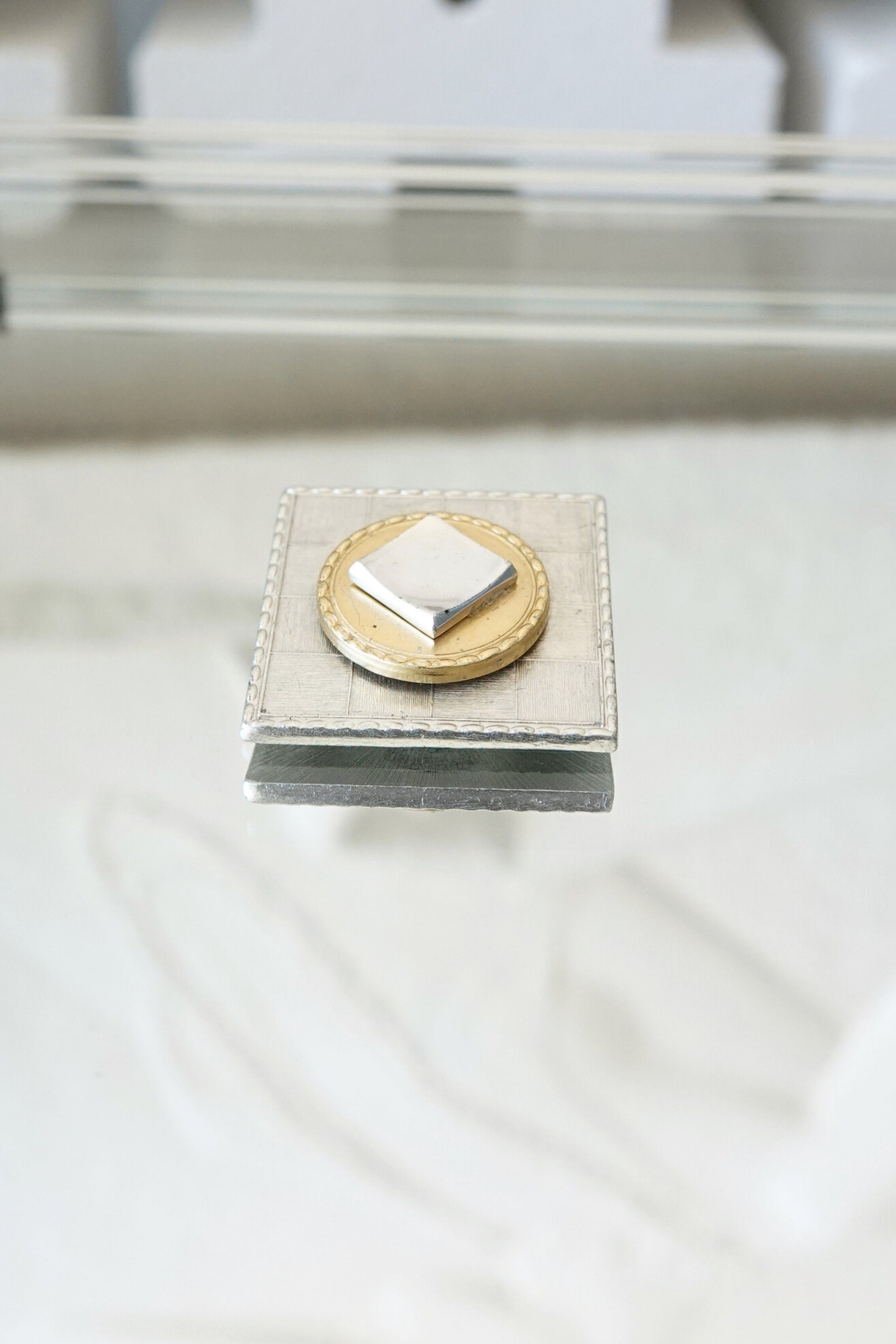 Vintage mixed metal square brooch, layered construction — styled top-down on stone prop — Disco Palma