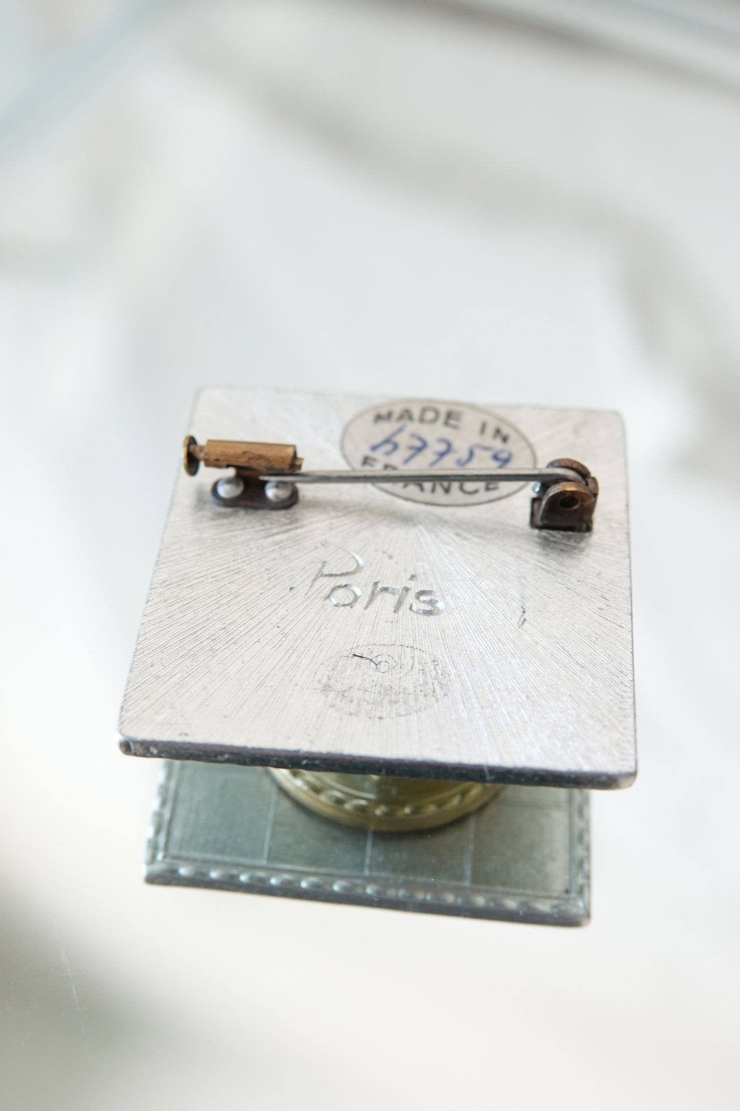 Paris brooch — back detail on glass showing pin mechanism
